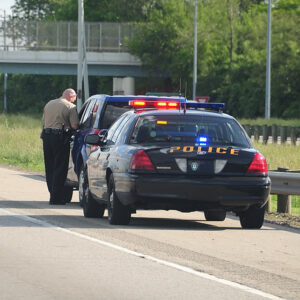 - Traffic Ticket Police Vehicle - A police cruiser with the lights flashing has stopped a speeding car along the interstate highway and is issuing a ticket. Who needs a DUI Attorney for First Offenses